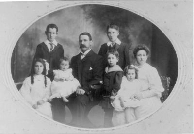 1906 - Michael and Margaret Carrucan with children Thomas, Francis, Monica, Leo and Kathleen
Michael Martin CARRUCAN (1866-1954), the son of Peter Carrucan, married Margaret LYNCH (1868-) in 1891. This photo shows them with their children

Thomas Michael CARRUCAN (1892-1951) - right back
Francis William CARRUCAN (1895-1967) - left back
Monica CARRUCAN (1896-1976) - left front
Leo CARRUCAN (1901-1958) - middle front
Marguerite (Madge) CARRUCAN (1903 - 1969) - right front being nursed
Kathleen CARRUCAN (1906-1992) - front second from left

Thomas Michael eventually moved to New Zealand where a large Carrucan clan now exists.
