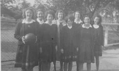 1946 - Betty Carrucan Basketball team Stawell High School
Career opportunities for women were few in the late 1940s and Betty (Elizabeth Agatha) Carrucan embarked on a teaching career after becoming the first Eltham girl to graduate from Melbourne University. As was the case in those days, her first teaching appointments were in the country regions. She spent a few years at each of Korrumburra, Leongatha, Wangaratta and Stawell. This photo, taken in 1946 at Stawell High School, shows her in basketball coach mode.
