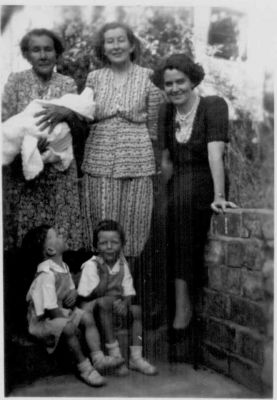 1950 - Mary Carrucan, Betty Erickson with children Mick Terry Tim as baby
Elizabeth Agatha (Betty) Erickson (nee Carrucan) at the Dalton St Eltham farm with her mother Mary Carrucan (nee Sweeney). With Betty are her 3 boys Mick, Terry and Tim (baby being held by his grand mother). Mary had married Mick Carrucan, the eldest son of the original Patrick Carrucan, and Mick farmed the Dalton St farm until his death in 1942. After his death, Mary continued on the farm, supported by her son John Francis (Jack) Carrucan and it was in that family environment that this photo was taken.
