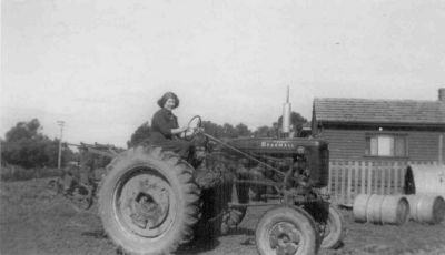 1950s - Mary Frances (Molly) Kelly nee Ganly
Mary Jane (Girly) Carrucan was born at Kew in Victoria on 1 July, 1889. She married Michael Ganly (1882-1955) at St. Patrick's Cathedral Melbourne on the 22nd February 1911 and they had eight children, John (Jack), Ellen Frances (Toppy), Mary Frances. (Molly), Kathleen, Margaret (Peg), Michael (Mick), Malachi (1926-1973) and Alicia. This photo shows Molly with her first tractor on the family property in then suburban Melbourne.
