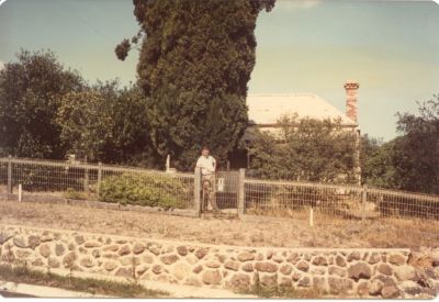 1966 - Jack Carrucan at Dalton St Eltham farmhouse
Patrick Carrucan's block was in Dalton Street in Eltham. This was not originally a Carrucan farm but was bought by the Carrucans in the 1850's from a farming family called Ball. The old homestead was on the corner of Bible and Dalton Streets and remained intact and occupied until Jack Carrucan died in 1976. The photo below shows Jack in front of the house. The photo shown was taken in 1966 and shows Jack at the front gate of the farmhouse, facing Bible St. All that remains now is the cyprus tree.
