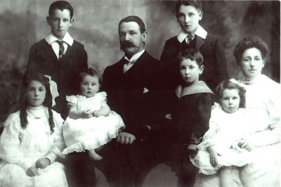 1906 - Carrucan family photo with children Frank 11, Tom 14, Leo 5, Mona 10, Marguerite(Madge) 2 and Kathleen 6 months
Michael Martin CARRUCAN (1866-1954), the son of Peter Carrucan, married Margaret Lynch (1868-) in 1891. This photo shows them with their children

Thomas Michael CARRUCAN (1892-1951) - right back, aged 14
Francis William CARRUCAN (1895-1967) - left back, aged 11
Monica CARRUCAN (1896-1976) - left front, aged 10
Leo CARRUCAN (1901-1958) - middle front, aged 5
Marguerite (Madge) CARRUCAN (1903 - 1969) - right front being nursed, aged 2
Kathleen CARRUCAN (1906-1992) - front second from left, aged 6 months

Thomas Michael eventually moved to New Zealand where a large Carrucan clan now exists.
