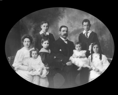 1906 - Michael and Margaret Carrucan with children Thomas, Francis, Monica, Leo and Kathleen - reverse
Michael Martin CARRUCAN (1866-1954), the son of Peter Carrucan, married Margaret LYNCH (1868-) in 1891. This photo shows them with their children

Thomas Michael CARRUCAN (1892-1951) - right back
Francis William CARRUCAN (1895-1967) - left back
Monica CARRUCAN (1896-1976) - left front
Leo CARRUCAN (1901-1958) - middle front
Marguerite (Madge) CARRUCAN (1903 - 1969) - right front being nursed
Kathleen CARRUCAN (1906-1992) - front second from left

Thomas Michael eventually moved to New Zealand where a large Carrucan clan now exists.

Note this is the reverse to another photo. Both have been separately sent and indicate that two original photos must exist, each the mirror image of the other. Strange but true!
