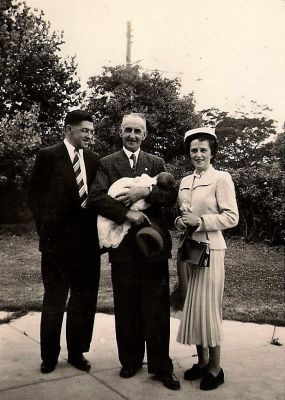 1954-01 Gavin Carrucan and Gwen Lodge at the christening of their first child Christine Mary Carrucan
Gavin Carrucan and Gwen Lodge at the christening of their first child Christine Mary Carrucan, who is being held by Gavin's father Francie William Carrucan. Christine is a great great grand daughter of Peter Carrucan and Hannah Woods. Photo sourced from Gavin's and Gwen's son Michael Carrucan and passed on by his nephew Kieran Magee, who is a great great grandson of Peter and Hannah.
