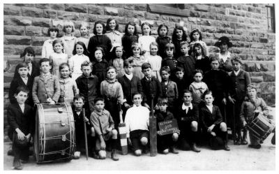 1921 Eltham Elementary School grades 3 and 4 - Patrick and Jack Carrucan Nellie Sweeney Teacher
The Eltham Elementary School in Dalton Street (School Number 209) had been started in the 1850s and was just a stone's throw from the Carrucan farms and not too far from Culla Hill. All the Carrucan and Sweeney children attended and this photo of the 1921 Grade 3 and 4 class shows 40 children ranging in ages from about 10 upwards. Nellie Sweeney is the teacher on the right. Patrick and Jack Carrucan are amongst the children. 
