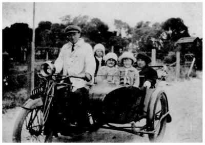 1923 Frank and May Ryan with Sheila Kitty and Ellie on their way to Eltham on motorbike and sidecar for Ellen Sweeney's wedding
Francis Michael "Frank" Ryan (1887-1965) was one of the children of John Francis Ryan (1855-1921) and Ellen Sweeney (1845-1932). 

He married Mary Ann "May" Smale in January 1916. 

Frank and May are shown on their motorbike with children Cecelia Mary "Sheila" (born 1916), Catherine Ellen "Kitty" (born 1917) and Eileen Margaret "Ellie" (born 1919). They had one further child, John Francis "Jack" who was born in 1924. At the time of this photo, there were only the 3 older daughters.
