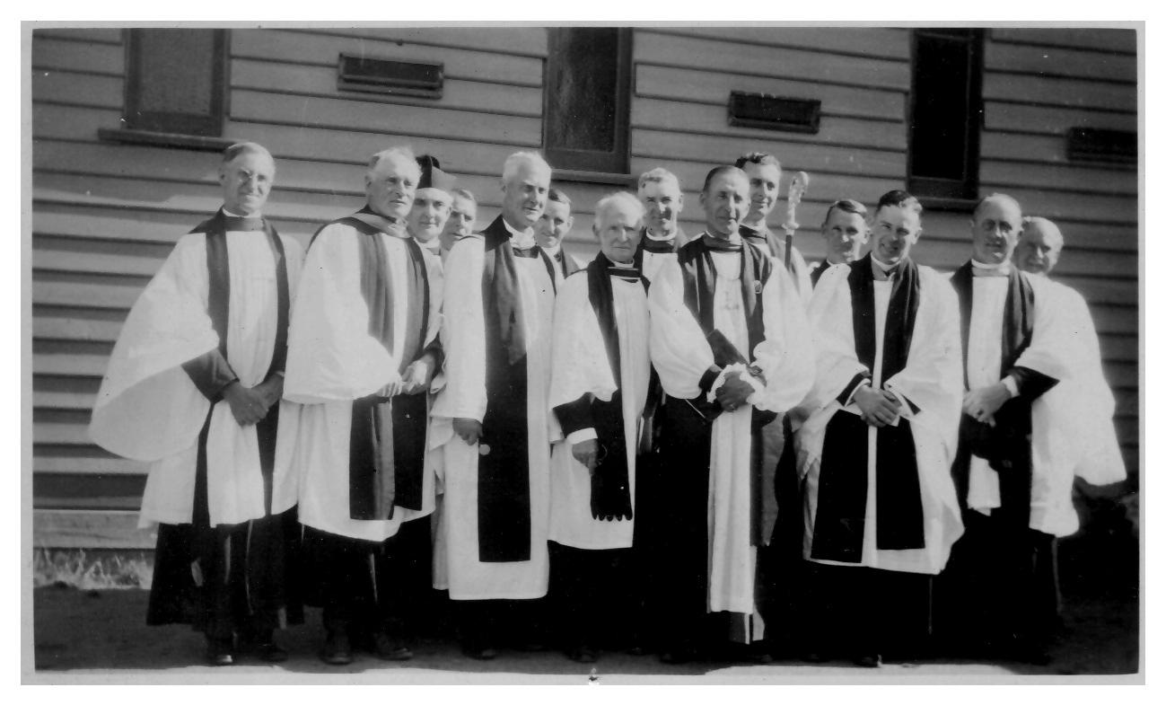 1932-02-20 - Laying of Foundation Stone - the attending clerics
In January 1932, when the church was under construction, Archbishop Head came for the placing of the memorial stone at the North East corner of the church porch (in Delta Avenue) on Saturday 20 February at 3 PM.  The inscription reads:
"To the greater glory of God.  This stone was laid on 20th February Anno Domii 1932 by the Most Rev. Frederick Waldergrave Head, D.D.' Archbishop of Melbourne.  Rev. W. Clarke Hudson, M.A.,  Vicar. C.R. Heath A.R.A.I.A., architect". 
The mayor (Cr J J Anderson), and other councillors were present, along with a large group of clergy which included Canon Rowed (who read the lesson),  the Rev C H Murray (in 1950, the Bishop of Riverena), who carried the Archbishop's staff,; the Revs H S Hollow, E I Gason, J W Briggs, W A Shaw, A R Sinclair, J A Peck, J J Tempany , L L Nash, A E Sedsman and J V Gason. 

