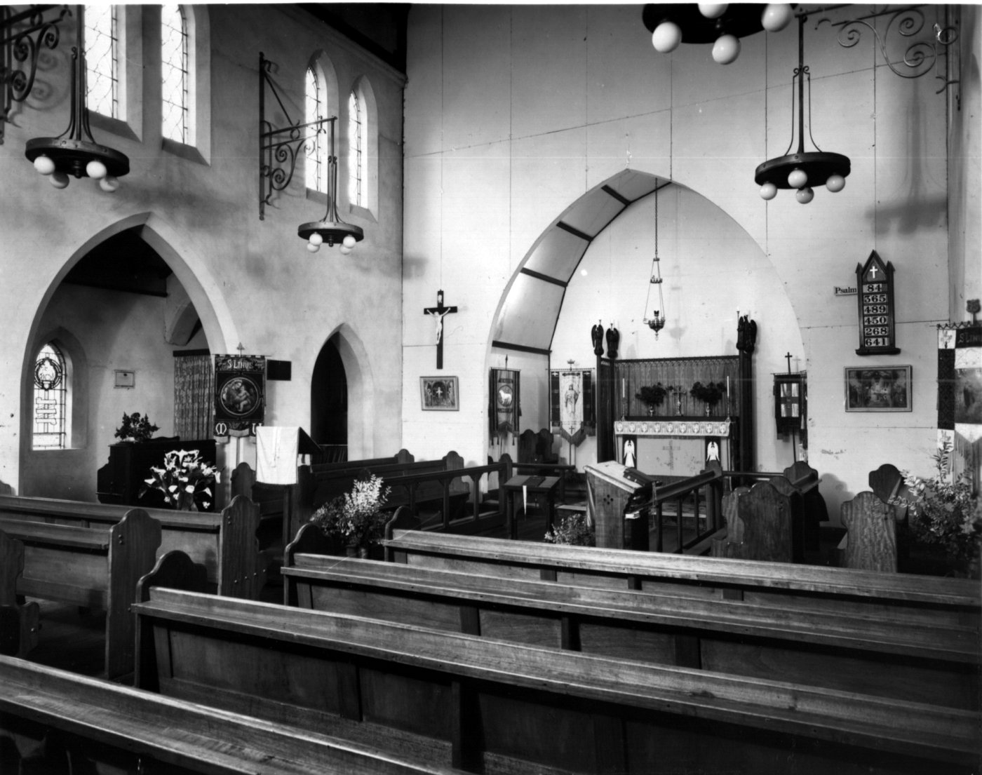 1950 Church interior
This framed photo, taken in 1950, is a wonderful snapshot of the church interior which enjoyed a local reputation for its beauty.  Note the 2 rows of choir stalls are on either side of the worship area. The church had been lovingly cared for by a number of people, particularly Ray Evenden, who had continued the English theme and had put much of his time into maintaining and adding to the decoration of the church.  Ray’s embroidery skills were on display in vestments used in worship and frontals and banners that furnished St Linus’.
