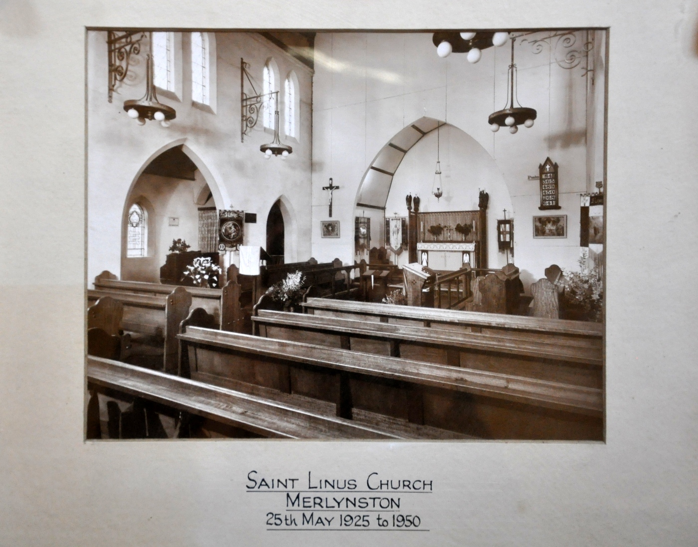 1950 Church interior Framed Picture
This framed photo, taken in 1950, is a wonderful snapshot of the church interior which enjoyed a local reputation for its beauty.  Note the 2 rows of choir stalls are on either side of the worship area. The church had been lovingly cared for by a number of people, particularly Ray Evenden, who had continued the English theme and had put much of his time into maintaining and adding to the decoration of the church.  Ray’s embroidery skills were on display in vestments used in worship and frontals and banners that furnished St Linus’.
