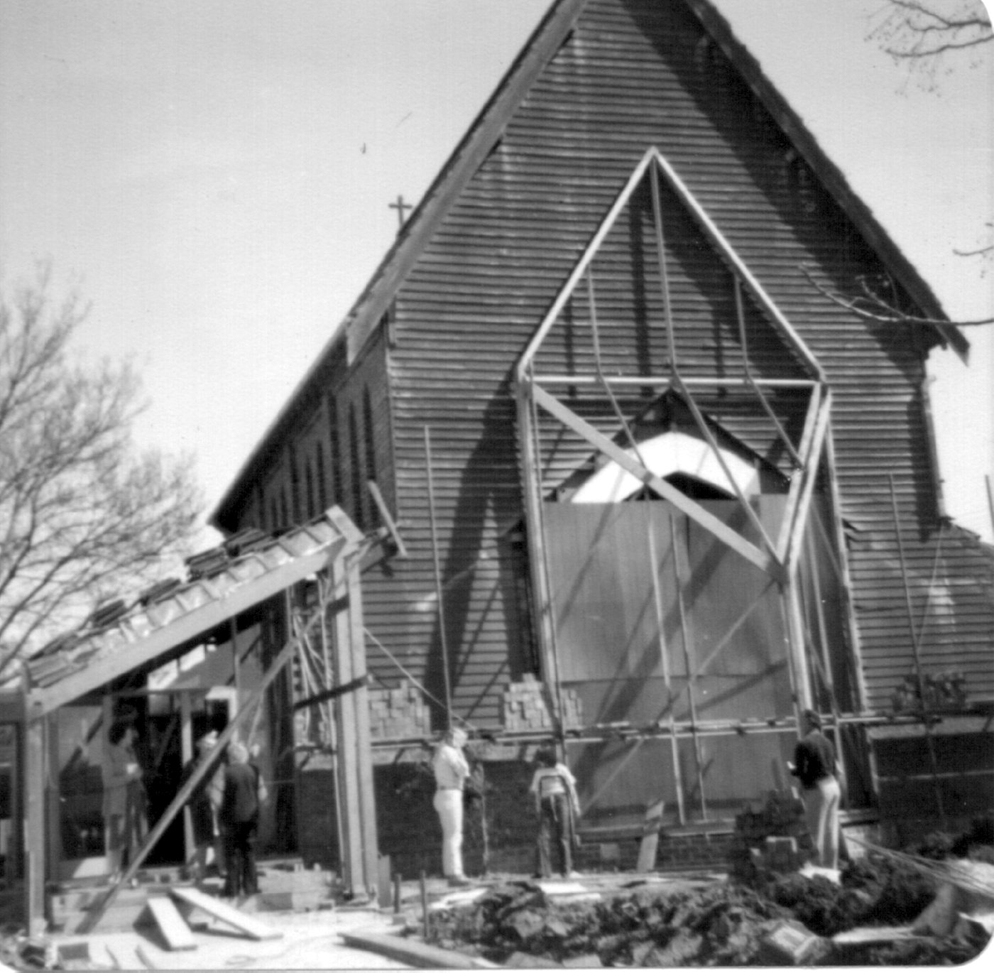 1978 Church Renovations 1
For years the unfinished wall of the church had been a source of embarrassment and was a physical reminder of the neglect of the parish over the years.  It also worked against the establishment of a solid foundation for ministry. In 1977, following the success of the planned giving programme, the Vestry decided, with the support of Bishop James Grant, that the building should be completed. Mr Vanne Trompf, a creative architect who had successfully carried out some work to Anglican churches, came up with a wonderful solution to replace the temporary wooden eastern wall with a new glass window. The renovation also included a new vestry and church entrance and required the altar to be moved from the eastern end to the western end of the church. The building work was completed and was blessed by Archbishop Robert Dann in a Re-dedication Ceremony on 5th November 1978.  A morning prayer service was held at 8:00 AM, followed by a prayer vigil which lasted until the re-dedication ceremony commenced at 4:00 PM. 
