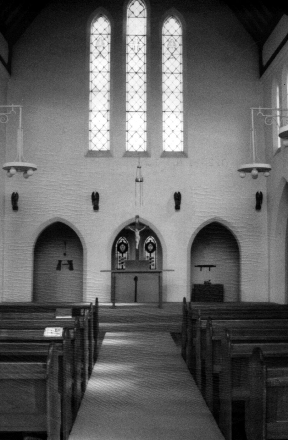 1988 Good Friday 1
The church, as it now stands, is a wonderful example of church architecture. 
The building is notable for its absence of ornamentation and for its lofty, well-proportioned interior. It is the only known example of Heath's church architecture, although he carried out considerable work at Fawkner Crematorium nearby.  
This photo shows the sanctuary, at the western end of the church.
