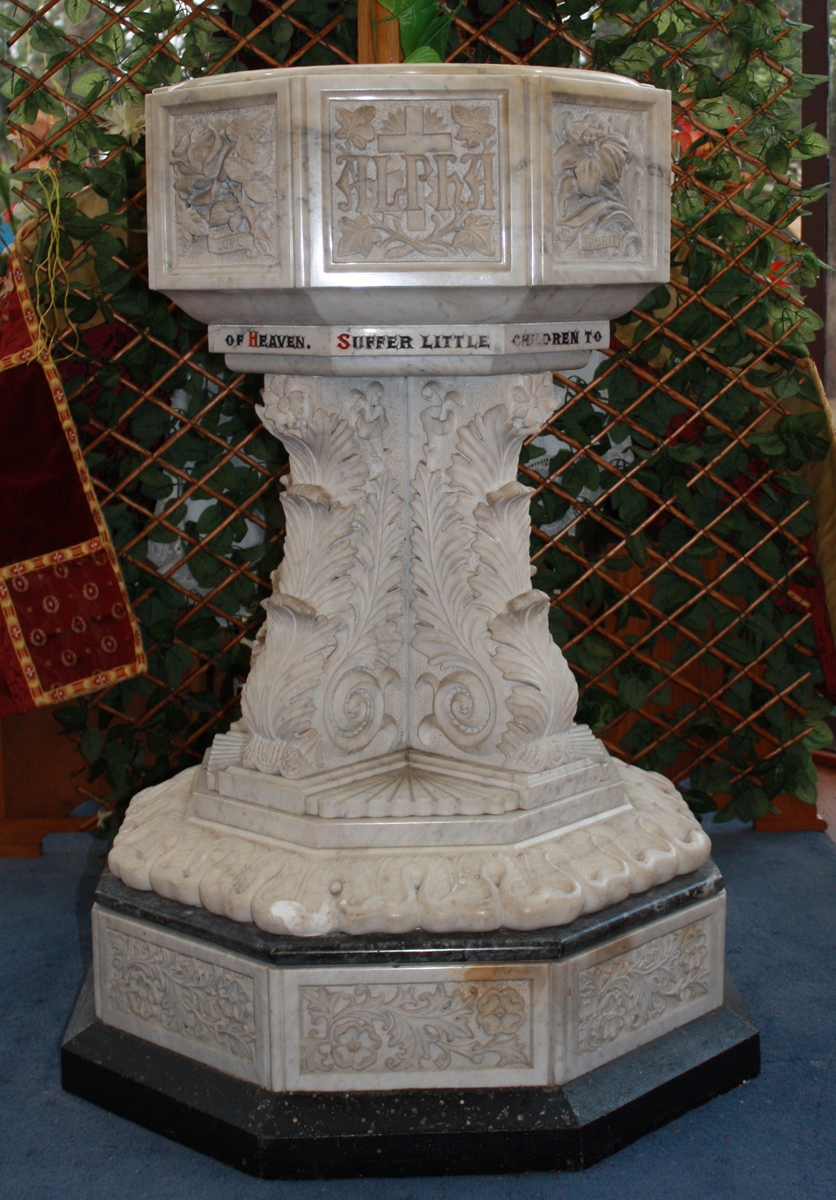 The St Linus Baptismal Font - Plaque
In November 1932, the church was the recipient of the magnificent gift of a marble font made secretly by Mr Hubert J Thornton over 2 years.  It was dedicated on Wednesday 23rd November at 8 PM by the Rural Dean, Canon Rowed.  The first baptism in the new font followed immediately, that of Mr Thornton's granddaughter, Patricia Joan Murray. The font has been much praised over the years and has pride of place in the large window of the completed church building, inviting passers-by to enter God’s kingdom through baptism. 
