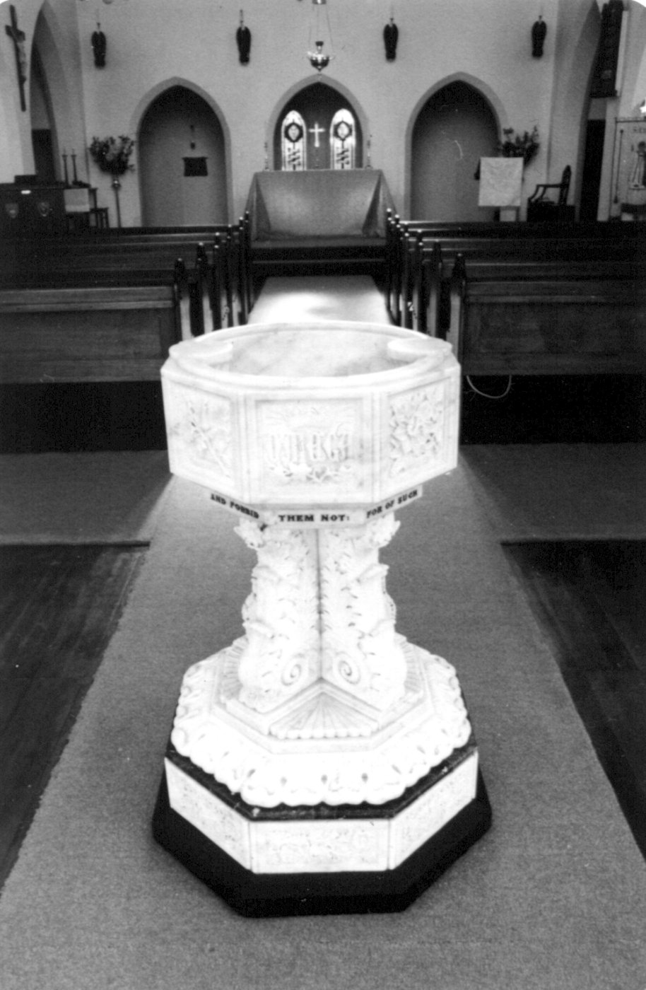 The Baptismal Font
In November 1932, the church was the recipient of a magnificent gift of the marble font, made secretly by Mr H J Thornton during 2 years' work.  It was dedicated on Wed 23 November at 8 PM by the Rural Dean, Canon Rowed.  The first baptism in the new font followed immediately, that of Mr Thornton's granddaughter, Patricia Joan Murray. The font has been much praised over the years and has pride of place in the large window of the completed church building, inviting passers-by to enter God’s kingdom through baptism. 
